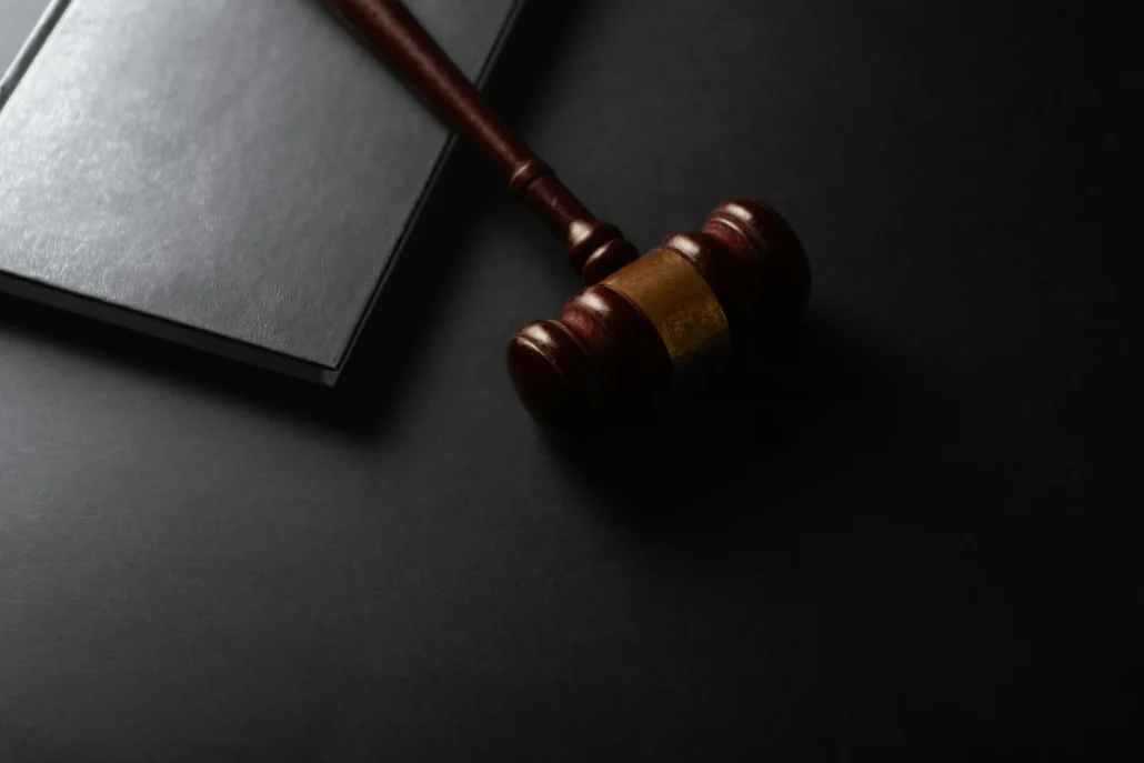 Are Poppers Drugs? Classification, Law and Facts (2026) 9 Judge gavel and law book on dark background — are poppers drugs classification